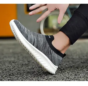 Close-up of breathable fly-knit mesh sock sneakers in grey and black texture.