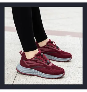 Close-up of wine red breathable mesh sneakers with thick grey soles for walking