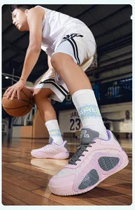 Dynamic close-up action shot of pink low-top breathable mesh basketball shoes on court