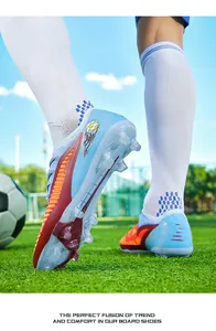 Detail view of blue flyknit soccer cleats featuring long studs for firm ground.