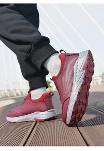 Detail view of maroon walking shoes with non-slip thick sole and leather surface.