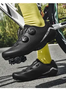 Detailed action view of black cycling shoes featuring a dual rotating buckle closure system