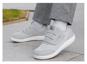 Close-up view of grey breathable mesh walking shoes with adjustable Velcro straps.