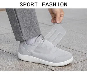 Detail view of grey mesh walking shoe with adjustable velcro strap for elderly
