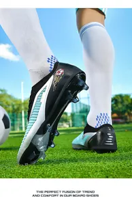 Close-up of low-top flyknit football cleats with long studs on green grass field