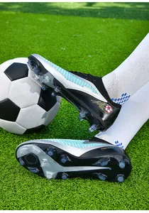 Detailed side view of low-top flyknit football shoes with transparent FG studs on grass