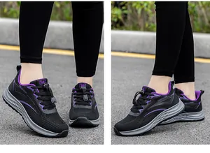 Lightweight black and purple fly-knit mesh running shoes shown on asphalt surface.