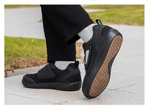Detail view of breathable black mesh walking shoes with practical Velcro straps
