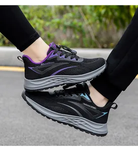 Close-up of black breathable mesh sneakers with purple and blue accents