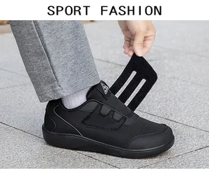 Close-up view of lightweight black mesh walking shoe with adjustable velcro straps