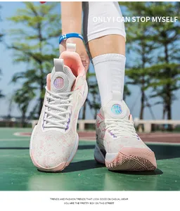 Macro view of pink and white basketball shoes showing breathable mesh upper on court.