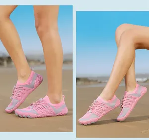 Detailed side and rear view of breathable pink mesh water shoes worn on a sunny beach