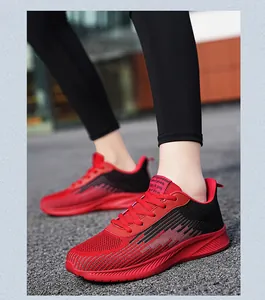 Breathable red and black knit mesh running shoes featuring a stylish textured design