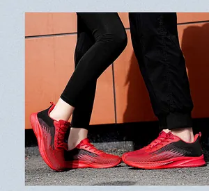 Detail view of stylish red and black flyknit running shoes with breathable mesh upper