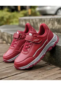 Close-up of red synthetic leather outdoor walking shoes with Velcro straps.