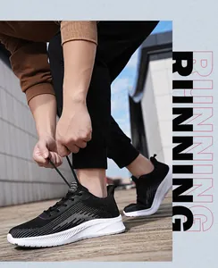 Close-up of black flyknit running shoes being tied, showing mesh detail and white sole.
