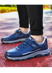 Detailed view of navy blue leather walking shoes with hook-and-loop strap for elderly