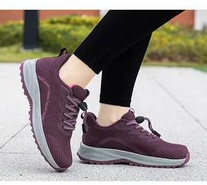 Detail of purple breathable mesh walking shoes worn by a person walking on pavement