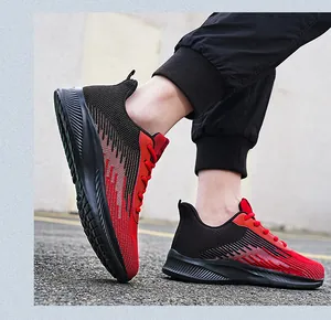 Detailed side view of red and black flyknit sneakers during outdoor running action