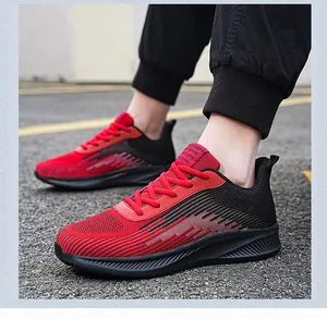 Detail view of red and black breathable mesh running shoes for men and women on asphalt