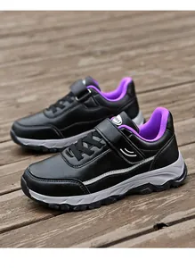 High-quality perspective view of black and purple outdoor walking shoes on a wooden deck