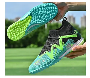 Detailed view of breathable soccer shoes with green TF studs and teal mesh upper.