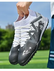 Close-up of high-top soccer shoes with textured black upper and sock-like collar