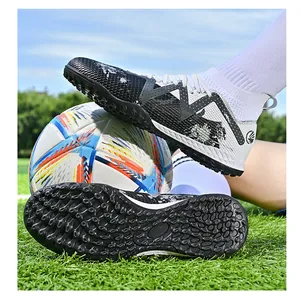 Detail view of kids turf soccer shoes with rubber studded sole for traction on grass