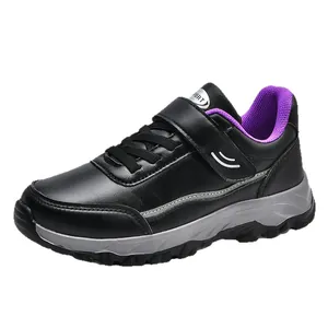 Black faux leather walking shoes featuring purple mesh lining and secure Velcro strap