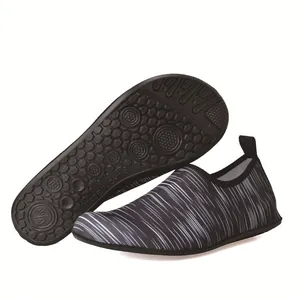 Detailed view of non-slip rubber sole on striped elastic water shoes for swimming