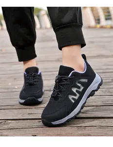Detailed view of breathable mesh walking shoes with toggle laces on wooden path.