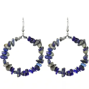 Macro detail of handmade circular hoop earrings with natural blue and grey stone chips.
