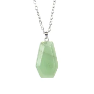 Detailed macro view of a natural green crystal stone coffin pendant on a silver chain