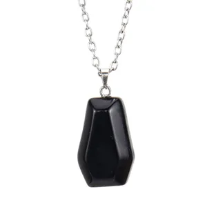Detailed view of a mini black natural crystal stone coffin pendant on silver chain.