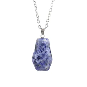 Macro view of blue natural stone coffin pendant with silver chain jewelry detail