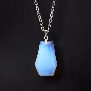 Detailed macro view of a translucent blue opalite coffin pendant with a silver chain