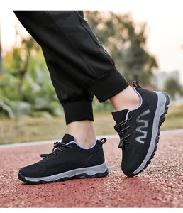 Detailed side view of black breathable mesh walking shoes with purple lining on outdoor track