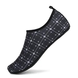 Detail shot of lightweight water shoes with black geometric grid pattern mesh upper