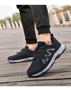 Close-up of black mesh walking shoes on a wooden boardwalk for outdoor activities.