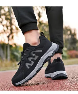 Close-up of black mesh outdoor walking shoes with toggle lacing system on a running track