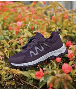 Detail view of purple mesh walking shoe on natural outdoor flower background.