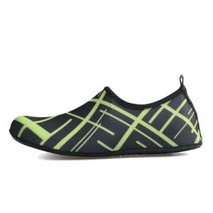 Side view detail of breathable black and neon green swim shoes with geometric patterns
