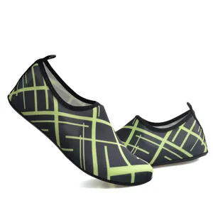 Macro view of lightweight swim shoes with vibrant neon green geometric patterns