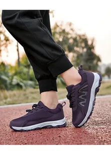 Detail showing purple breathable mesh walking shoes for seniors on outdoor track.