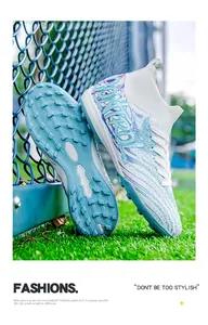 Close-up of white high-top soccer shoes with blue turf sole and mesh fabric design