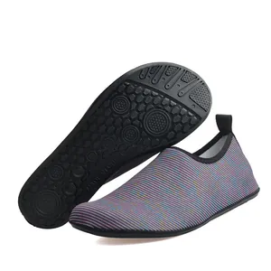 Detailed close-up of striped water shoes featuring a non-slip honeycomb sole