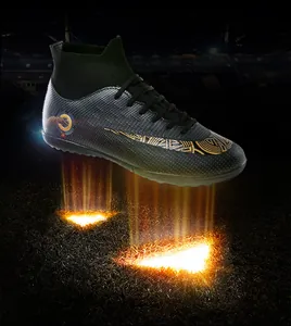 Dynamic close-up of high-top soccer cleat in black and gold with detailed tribal pattern