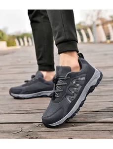Detailed close-up of grey mesh walking shoes with quick-lace system on a wooden deck