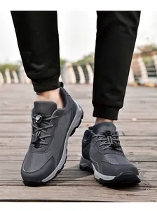 Detailed view of grey breathable mesh outdoor walking shoes on a wooden boardwalk