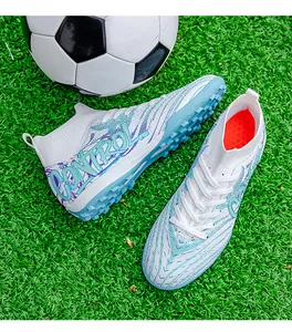 Top-down view of high-top soccer shoes on artificial turf with a football detail.